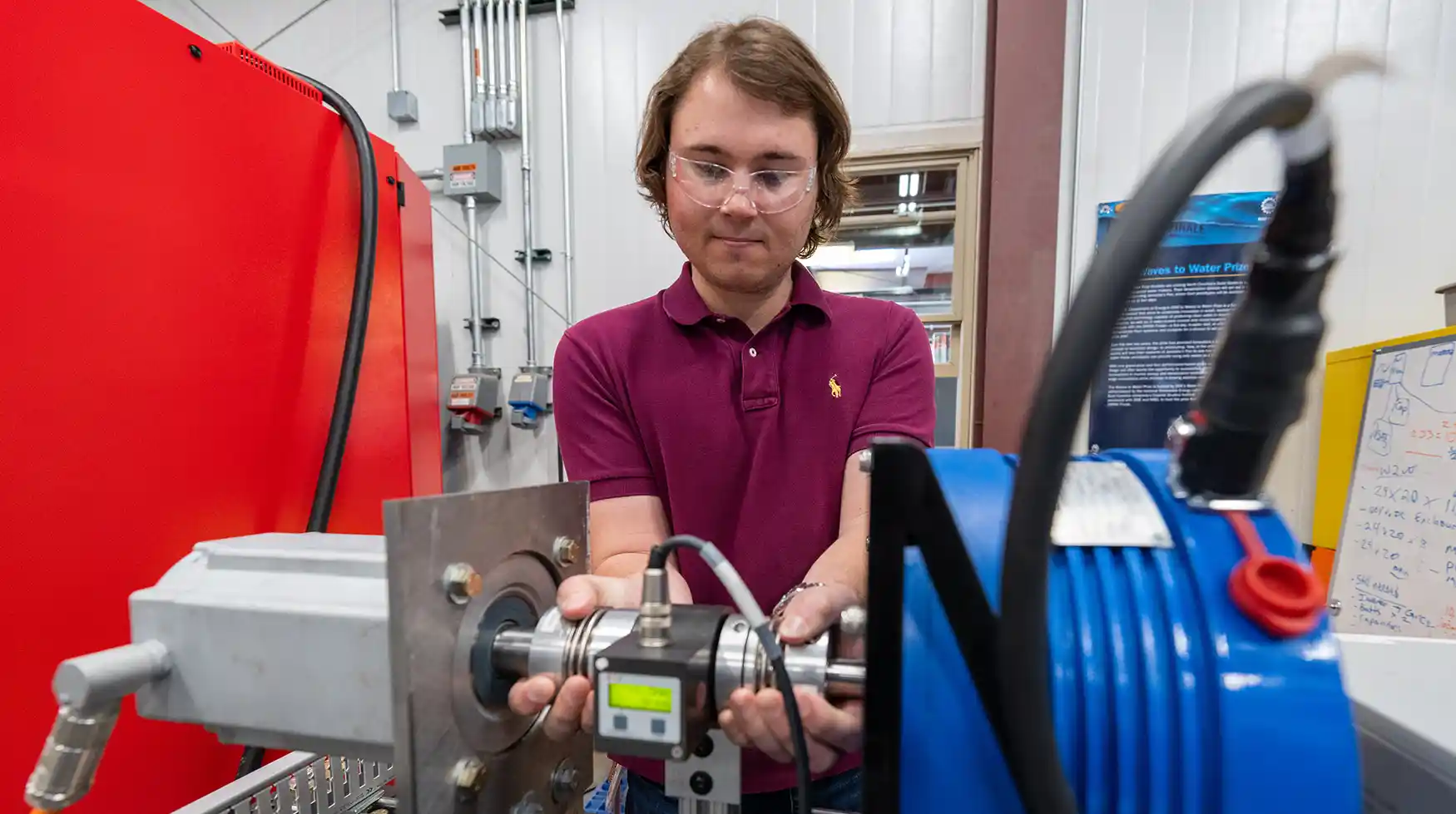 Researcher working on equipment in a laboratory.