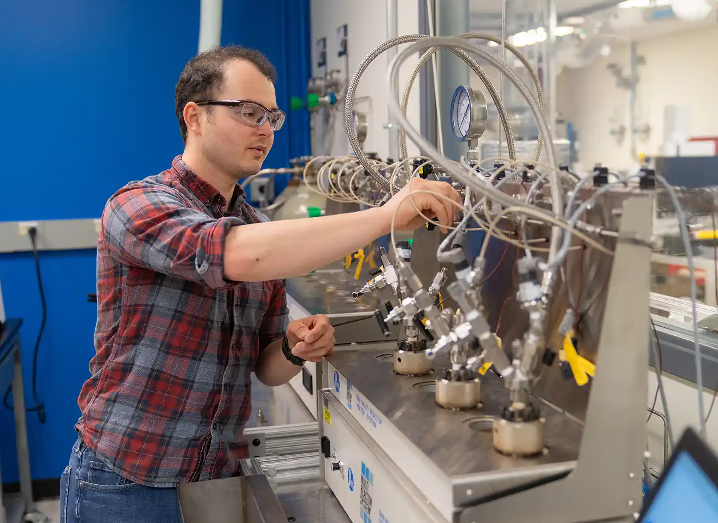 A scientist works with a reactor.