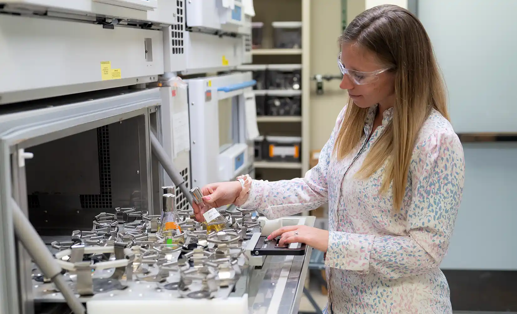 mining-industry-agriculture-innovations-93411 NREL researcher in lab prepares inoculated engineered bacteria in shake flasks.