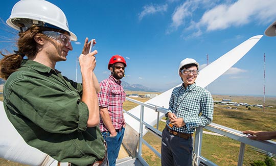 interns-cc-39186 Researchers on top of wind turbine.