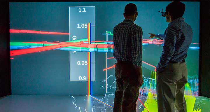 34487-720-thumb Two people looking at a data visualization projected on a screen.