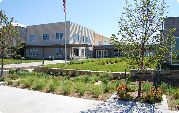 photo-project-kansas-19952 Photo of a new school building behind a flag pole and trees.