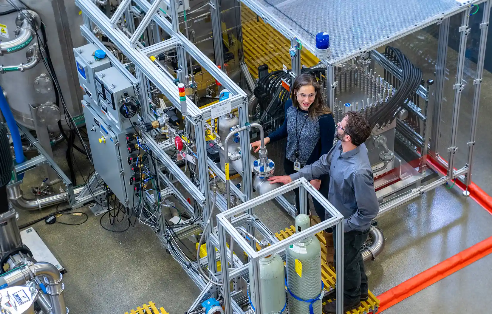 A system of interconnected pipes and two people.