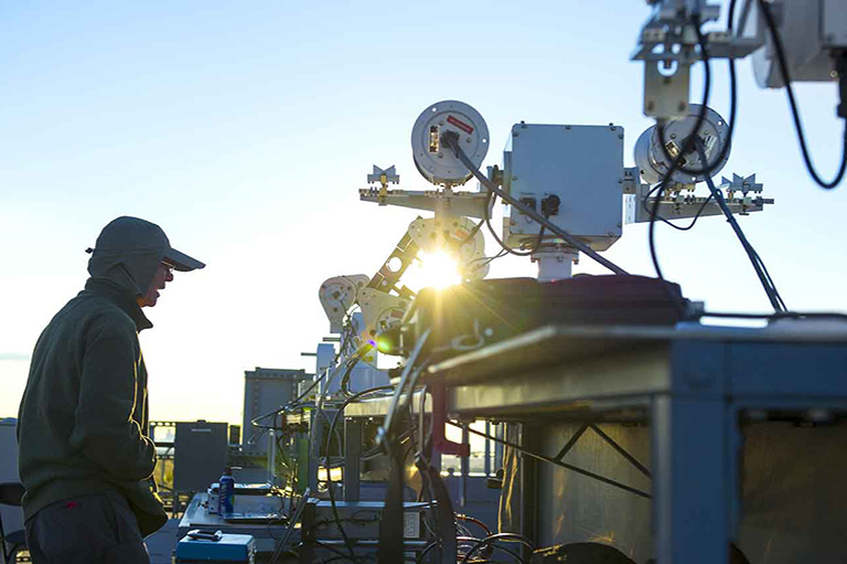 facilities-solar-radiation-lab-22509-thumb Person stands next to solar radiation measurement tool outside