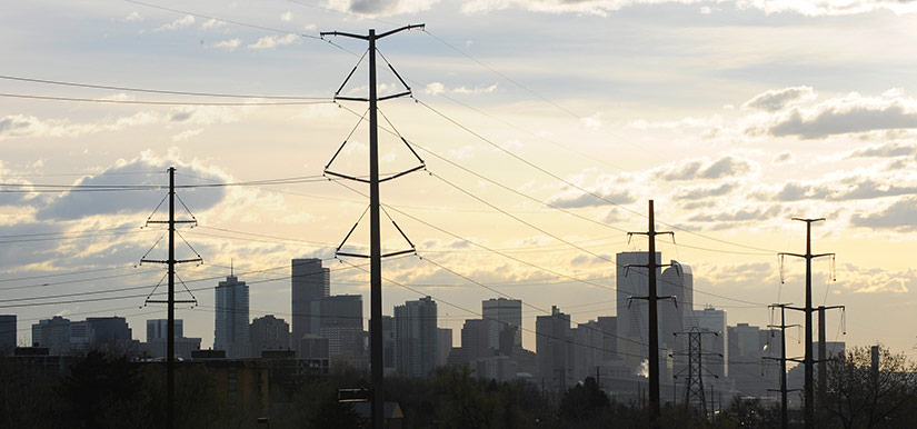 transient-dynamic-stability-18980 Photo of power lines with the Denver skyline in the background.