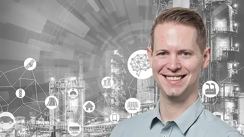 Portrait of Paul Meyer in front of manufacturing graphic.