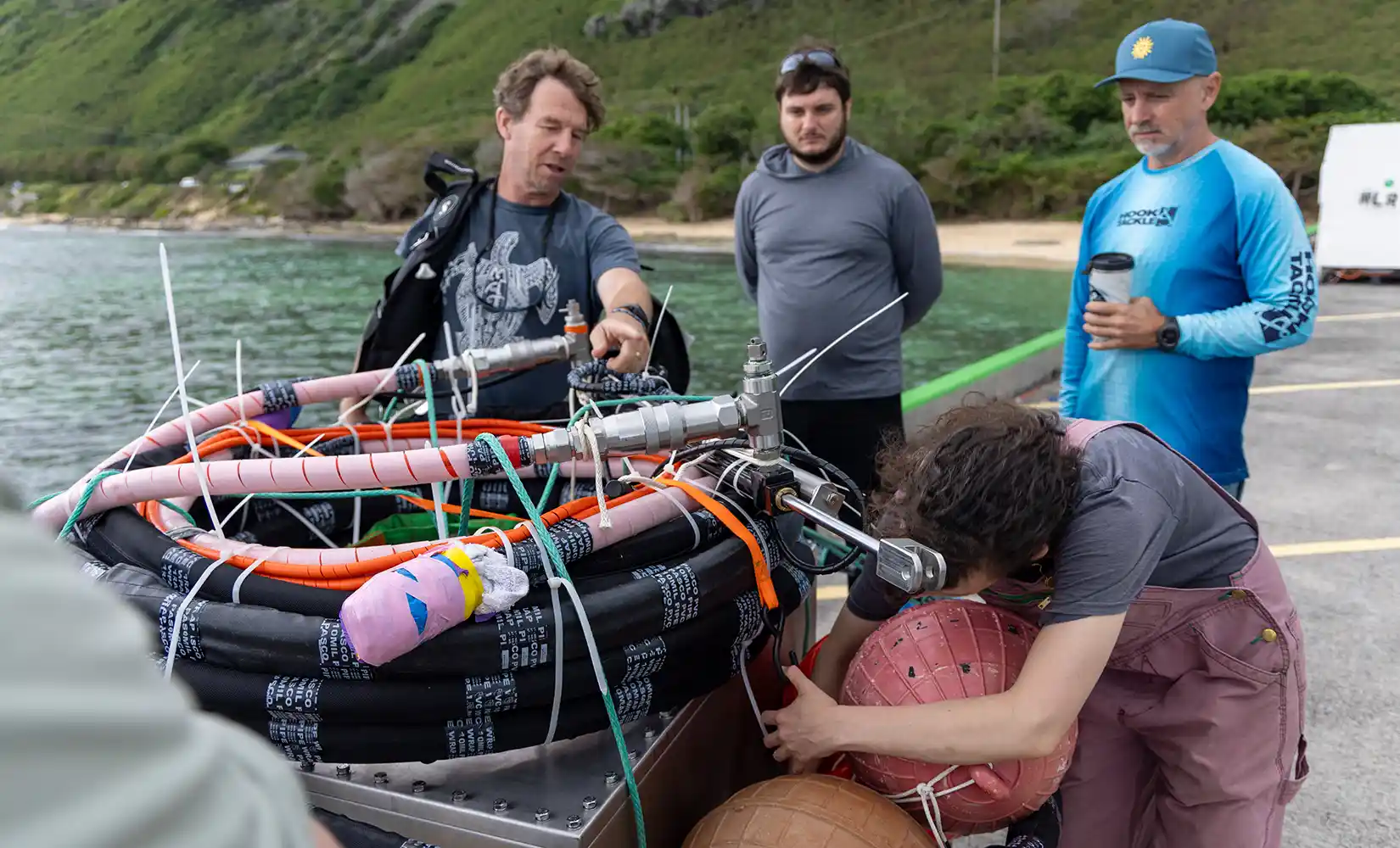 Researcher unloading the SURF-WEC's power takeoff system enclosure from a truck.
