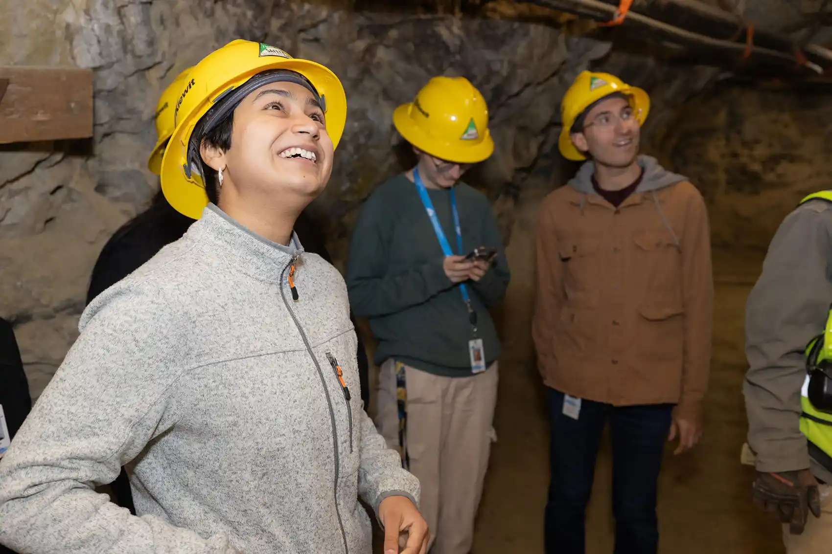 20260817-unearthing-the-future-inside-nlr-summer-educational-programs-106513 Three people in hard hats looking around a mine shaft.