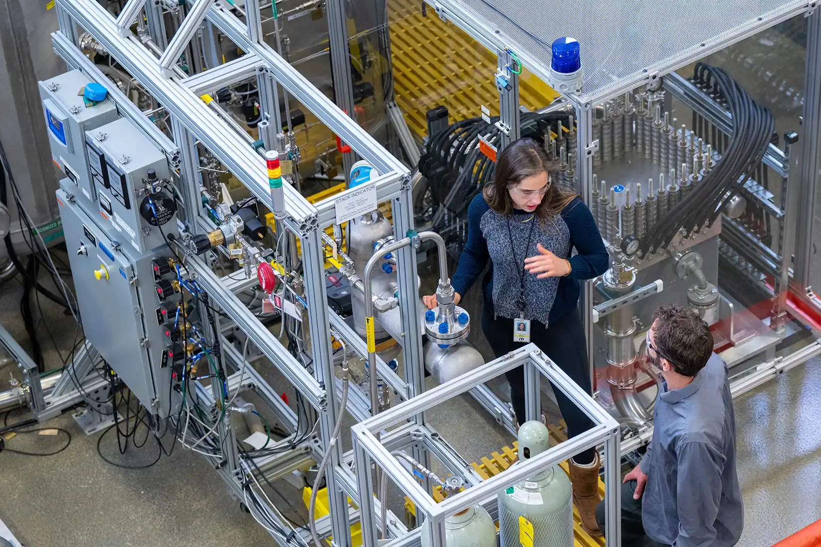 Looking down into a laboratory as two researchers collaborate.