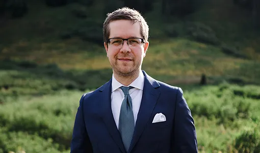 A man wearing a suit standing outside