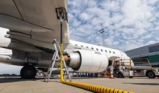 Continue reading about A parked airplane refuels using an aboveground fuel line.