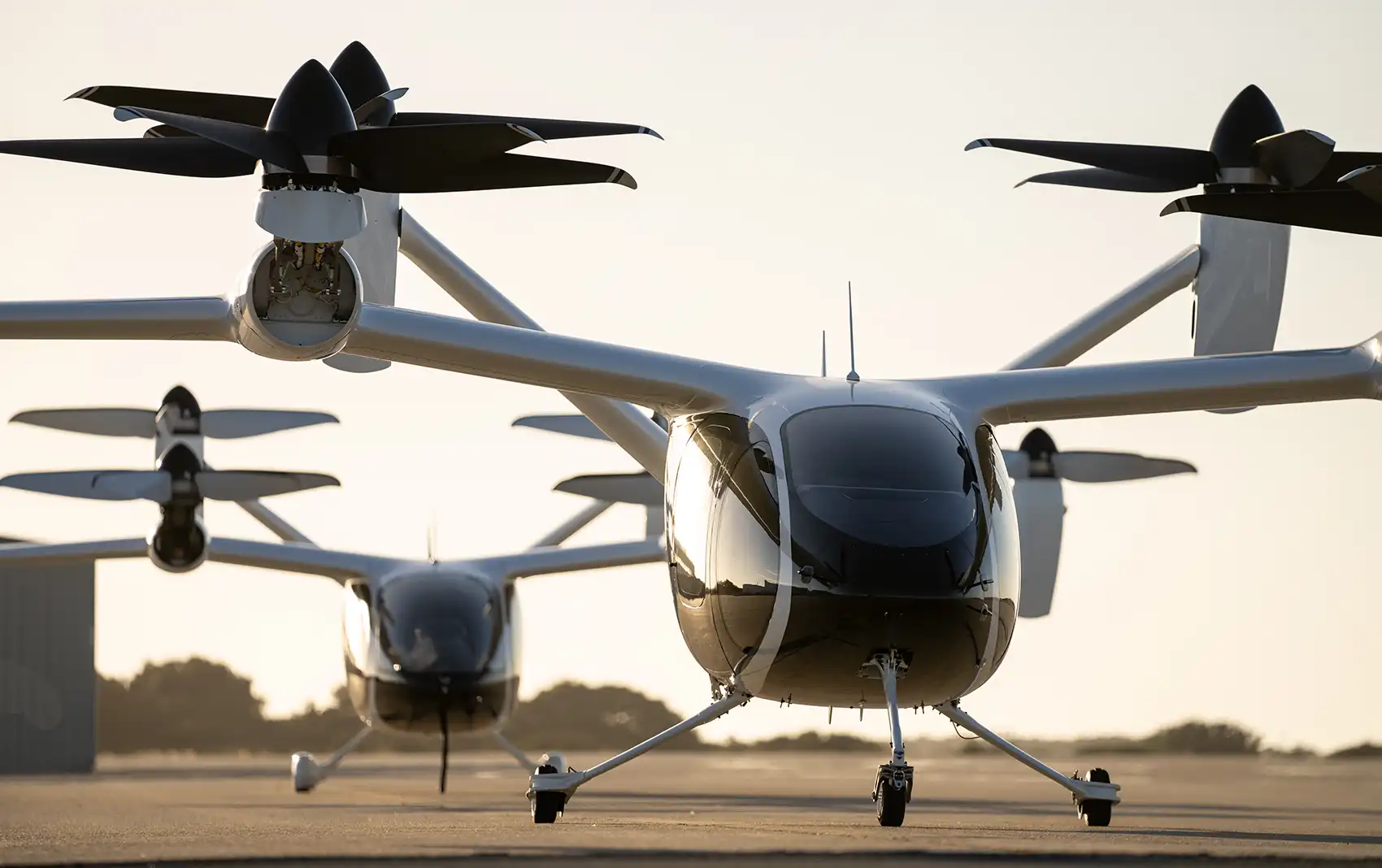 Two quadcopter-style vertical take-off and landing aircraft.