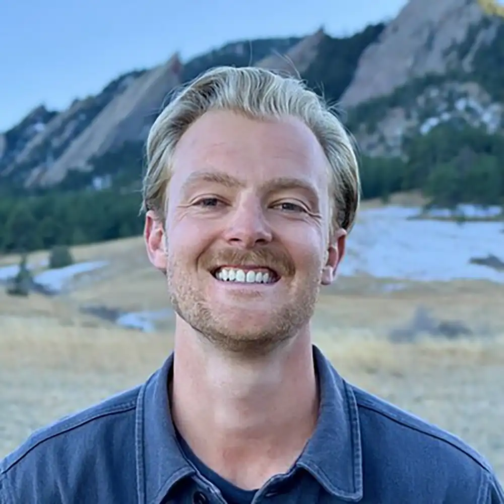 20260901-from-tony-stark-obi-wan-kenobi-meet-4-west-gate-fellows-and-their-technologies-evan-flitz Portrait of a person in front of mountains.