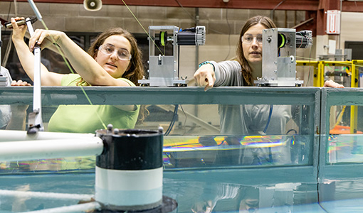 Nora and Hannah Ross testing a floating marine turbine platform in the NLR Sea Wave Environmental Lab.