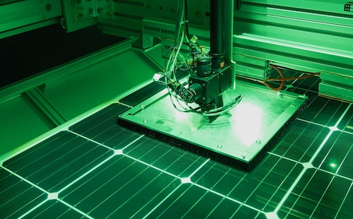 hp-spectral-response-testbed A solar module sits underneath a square shade that covers several cells around the measured cell. A bundle of black fibers runs from LEDs to the center of this shade to measure the desired cell.