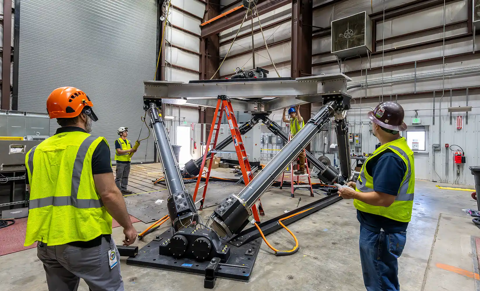 Researchers work on a marine energy device inside a laboratory.