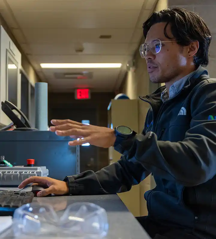 Researcher works on computer inside lab