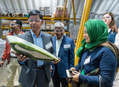 usaid-78378 Two people look at a green and white object that one person holds.